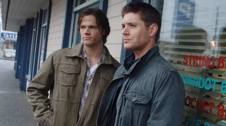 Sam and Dean standing outside building Supernatural
