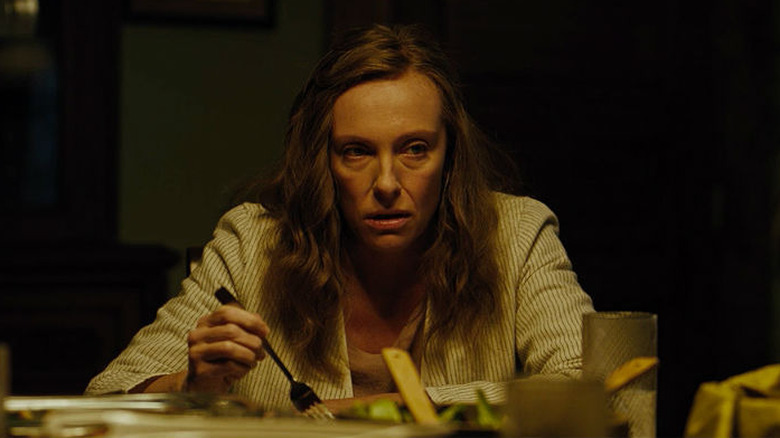 women sitting at dinner table in fear