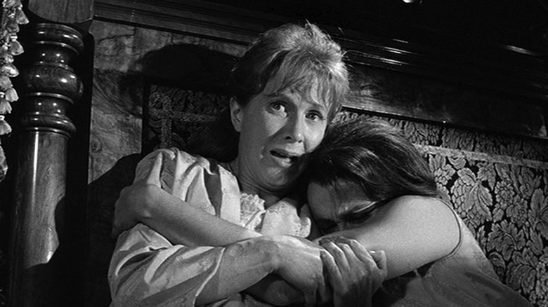 two women hide in fear