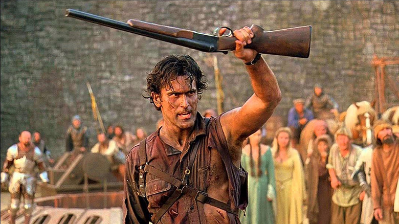 Ash Williams (Bruce Campbell) brandishes a shotgun in Arthurian England in Army of Darkness