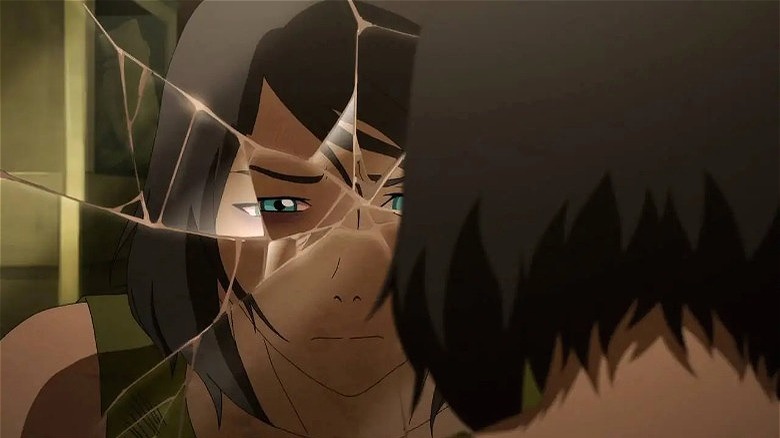 Korra looking at herself in a broken mirror