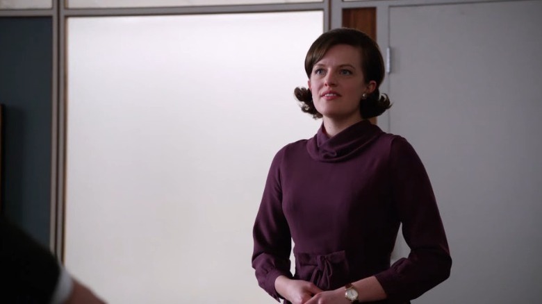 Elisabeth Moss as Peggy Olson standing in an office on Mad Men