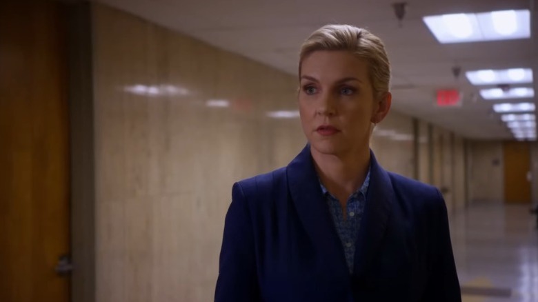 Rhea Seehorn as Kim Wexler standing in a courthouse corridor in Better Call Saul
