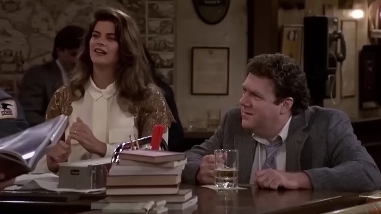 Kirstie Alley's Rebecca and George Wendt's Norm listen to their bartender on Cheers