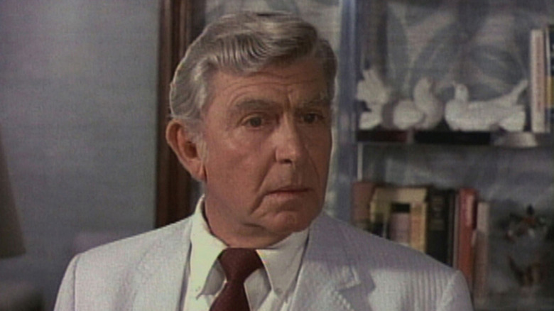Andy Griffith as Ben Matlock looks off-screen in a living room in Matlock