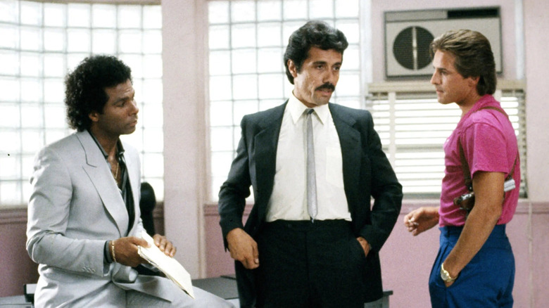 Don Johnson as Sonny Crockett and Philip Michael Thoomas as Rico Tubbs talk to Edward James Olmos as Martin Castillo in his office in Miami Vice