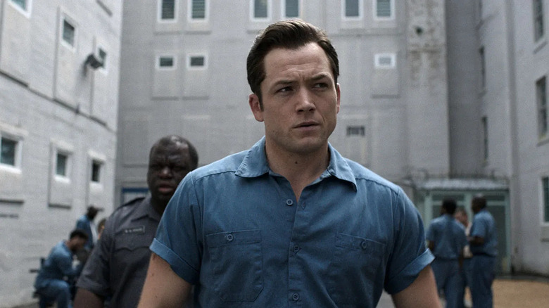 James Keene (Taron Egerton) walking through prison yard on Black Bird