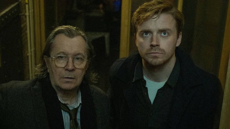 Jackson Lamb (Gary Oldman) and River Cartwright (Jack Lowden) at someone's front door on Slow Horses