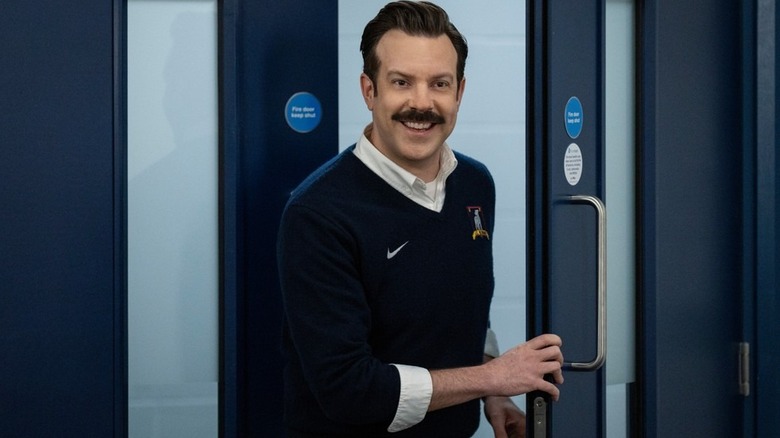 Ted Lasso (Jason Sudeikis) walking through a door on Ted Lasso
