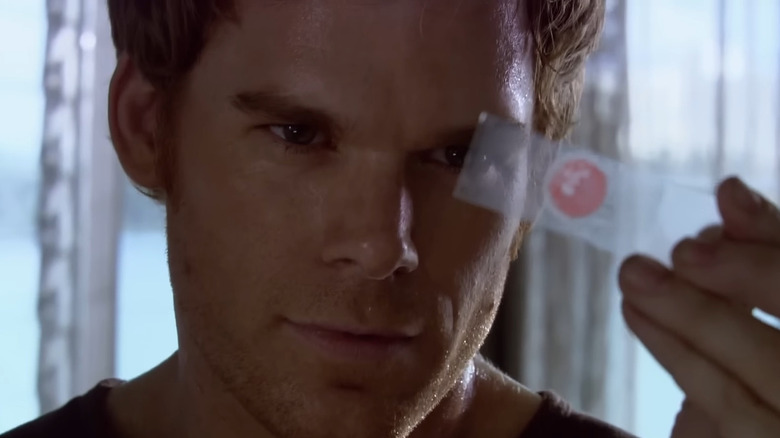 Michael C. Hall as Dexter Morgan staring at a blood slide in Dexter