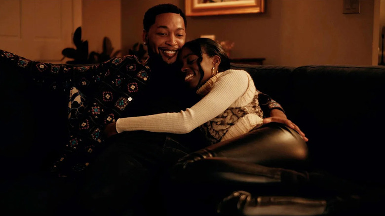Jacob Latimore and Birgundi Baker as Emmet Washington and Kiesha Williams cuddling in The Chi