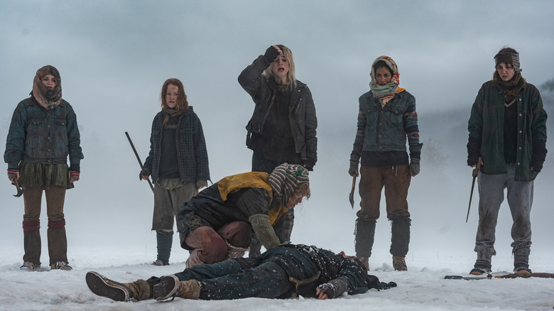 The Yellowjacket survivors stand over a corpse on Yellowjackets