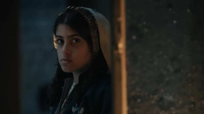 Karam Taher as Farha looking sternly to her left in Farha