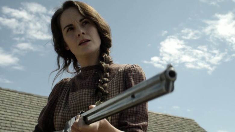 Michelle Dockery as Alice Fletcher pointing a shotgun on Godless