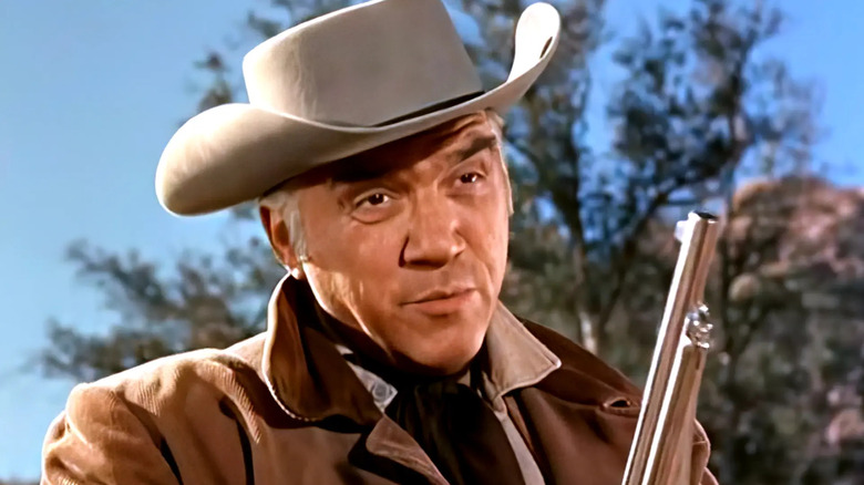 Ben Cartwright (Lorne Greene) holds a rifle in Bonanza