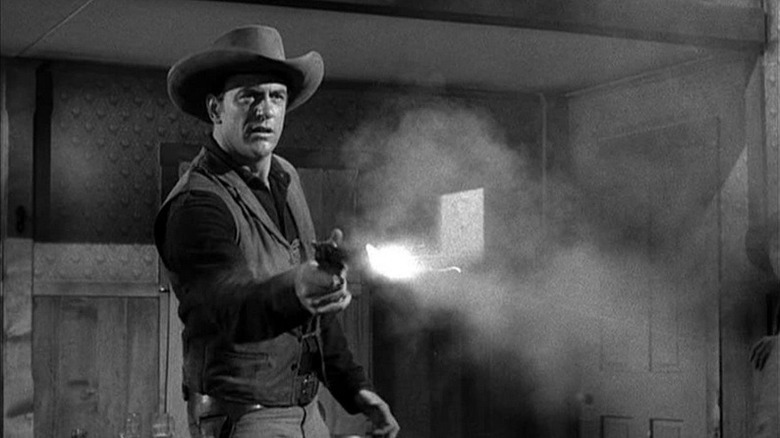 Matt Dillon (James Arness) fires a revolver in Gunsmoke