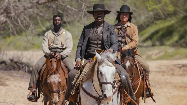 Bass Reeves (David Oyelowo) rides a horse with two other riders in Lawmen: Bass Reeves