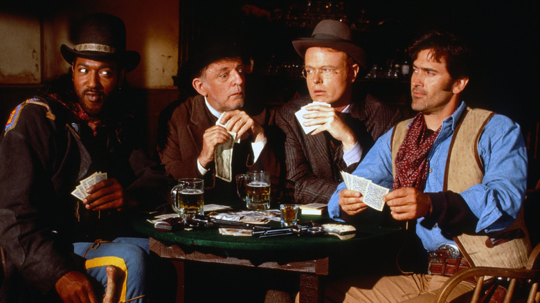 Brisco County, Jr. (Bruce Campbell) plays poker with Socrates Poole (Christian Clemson) and Lord Bowler (Julius Carry) in The Adventures of Brisco County, Jr.