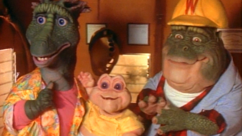 Fran Sinclair sits next to Baby and Earl Sinclair in an office in Dinosaurs