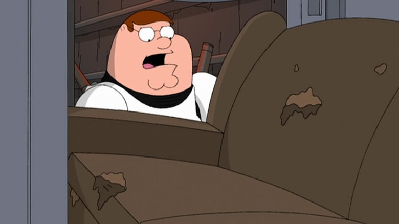 Peter Griffin trying to fit a couch through a doorway on Family Guy