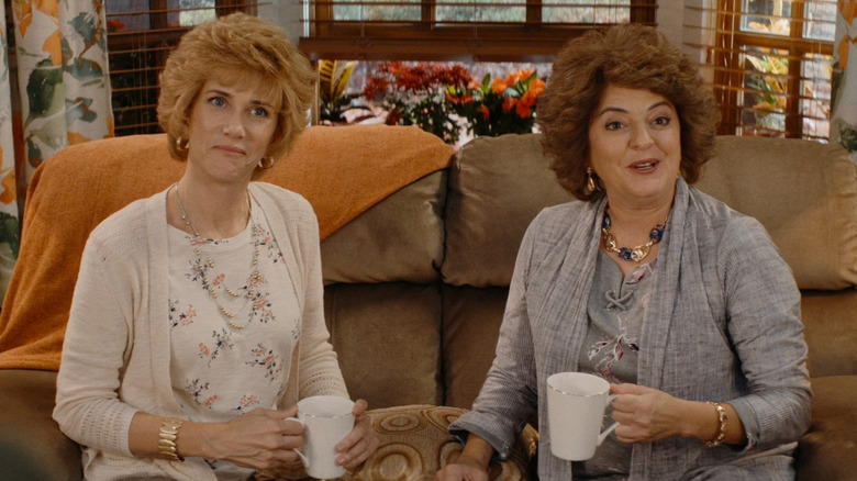 Kristen Wiig and Annie Mumolo as Barb and Star holding mugs and sitting on a couch in Barb and Star Go to Vista Del Mar
