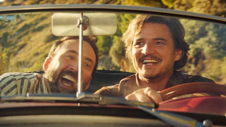 Nicolas Cage as himself staring at Pedro Pascal as Javi in a car in The Unbearable Weight of Massive Talent