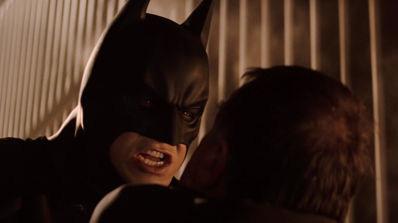 Batman intimidates a thug