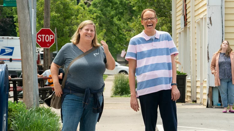 Bridget Everett as Sam and Jeff Hiller as Joel, laughing and walking down the street in Somebody Somewhere