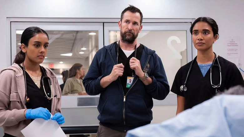 Shabana Azeez as Javadi, Noah Wyle as Dr. Robbie, and Supriya Ganesh as Dr. Mohan, standing in hospital on The Pitt