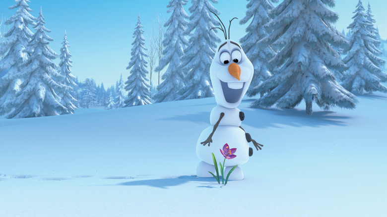 A smiling Olaf (Josh Gad) finds a flower growing through the snow in Frozen