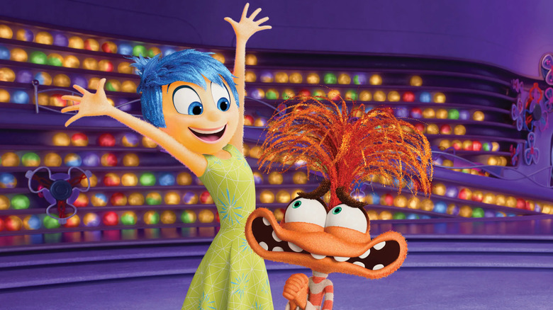 Joy (Amy Poehler) raises her hands next to a nervous Anxiety (Maya Hawke) in Inside Out 2