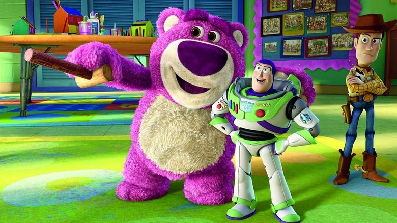 Lotso (Ned Beatty) points out the daycare to Buzz Lightyear (Tim Allen) as Woody (Tom Hanks) stares suspiciously in Toy Story 3