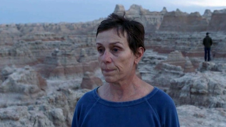 Fern (Frances McDormand) examines the desert in Nomadland