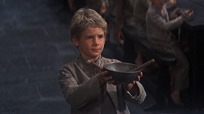 Oliver (Mark Lester) asks for some more in Oliver!