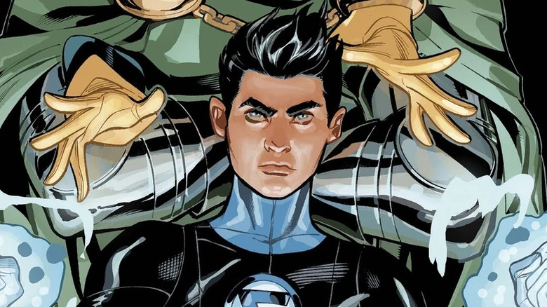 Franklin Richards wearing his black Fantastic Four suit and summoning blue energy while standing in front of Doctor Doom in a Marvel Comics image