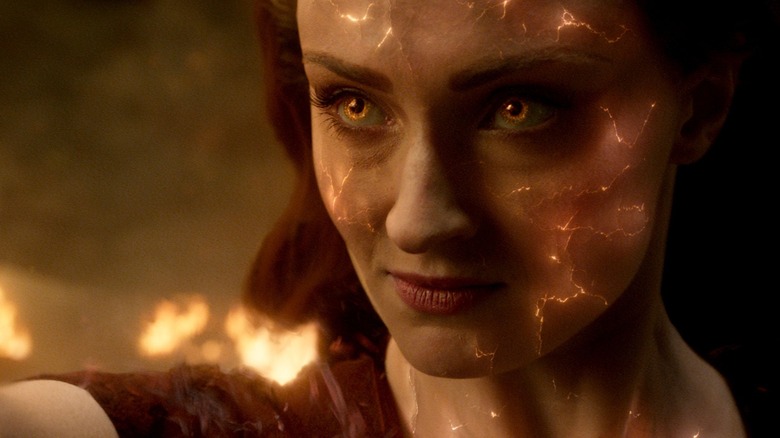 Sophie Turner as Jean Grey with fiery eyes and cracked, fiery skin in Dark Phoenix