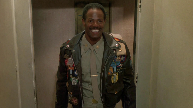 Jack Spade (Keenen Ivory Wayans) smiles in a hall while wearing a military jacket and uniform in I'm Gonna Git You Sucka