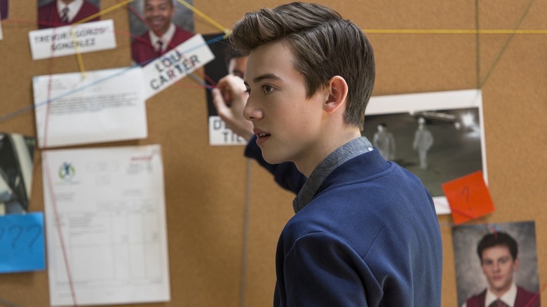 Griffin Gluck's Sam Ecklund looking at the evidence board on American Vandal