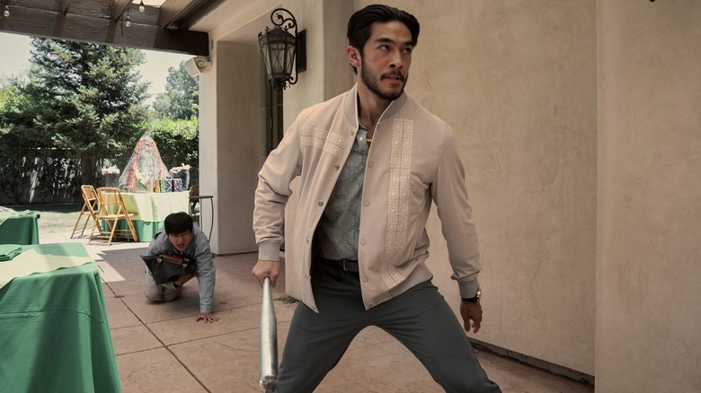 Sam Song Li's Bruce Sun ducking and Justin Chien's Charles Sun holding a bat in The Brothers Sun