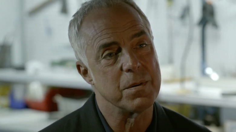 Detective Harry Bosch (Titus Welliver) examines someone in Bosch