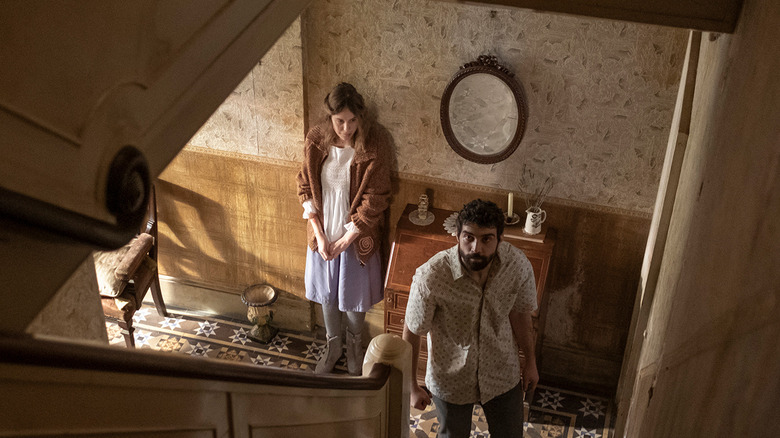 Carla Juri, Alec Secareanu Amulet look up stairs