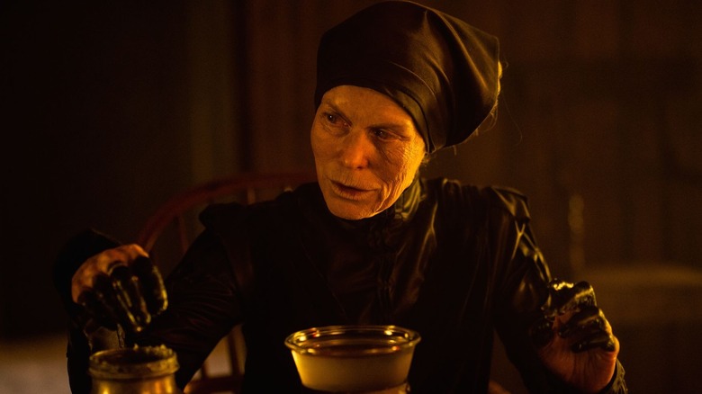 Alice Krige as the witch in Gretel & Hansel serves food