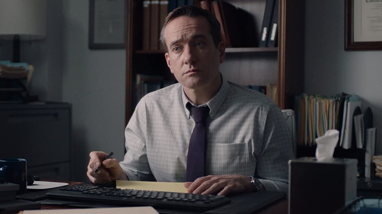 Matthew Macfadyen eagerly sits at desk