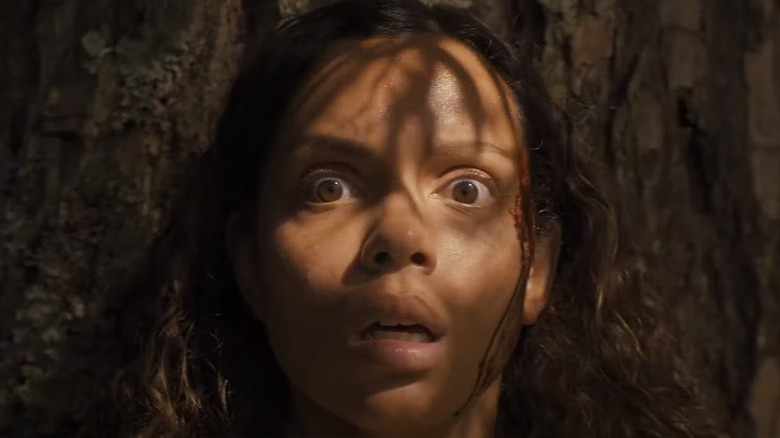 Georgina Campbell as Lennon, scared in the forest, in Lovely, Dark, and Deep
