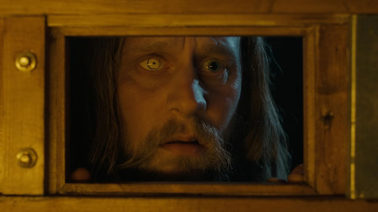 Tadhg Murphy as Olin, wanting into the house, in Oddity