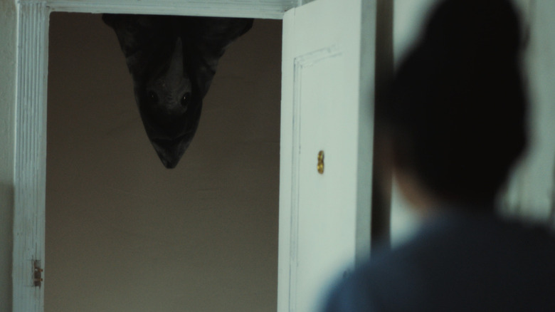 An uninvited visitor at the door in The Harbinger