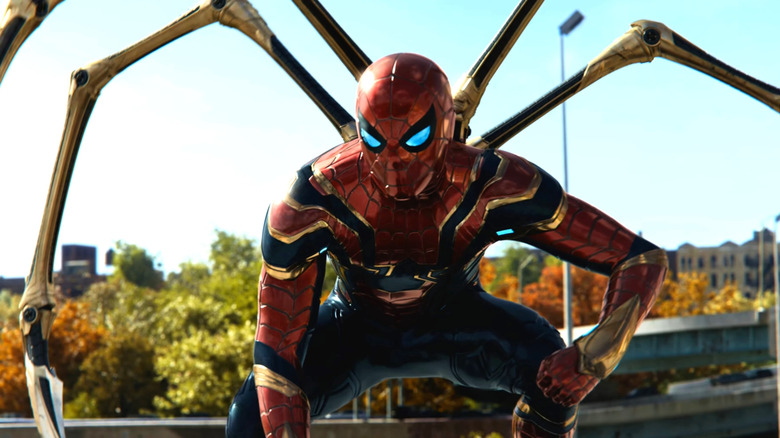Tom Holland as Spider-Man posing with his mechanical arms in Spider-Man: No Way Home