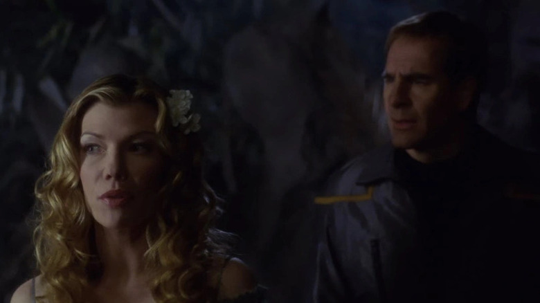 The Wraith (Stephanie Niznik) leads Jonathan Archer (Scott Bakula) in the dark in Star Trek: Enterprise