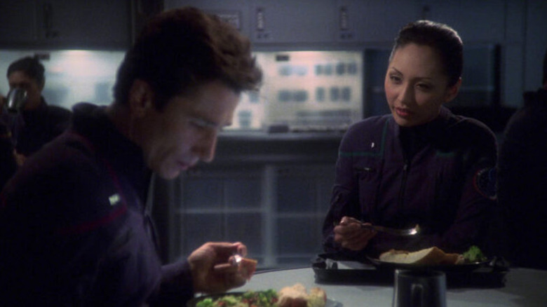 Hoshi Sato (Linda Park) tries to talk to a distracted Malcom Reed (Dominic Keating) in Star Trek: Enterprise