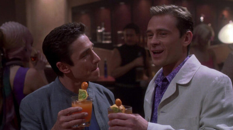 Malcolm Reed (Dominic Keating) and Trip Tucker (Connor Billingsley) wear suits and hold exotic drinks in Star Trek: Enterprise